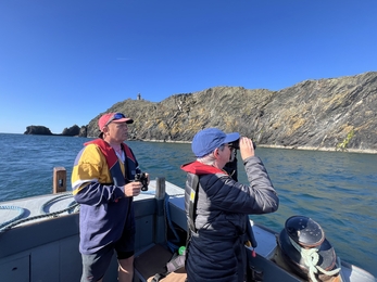 Matt and Cathy counting seabirds from the boat