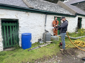 Warden learning how to use the fire fighting equipment on the Calf