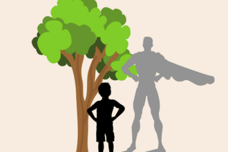 Image shows a boy stood next to a tree but his shadow is in the shape of superhero.