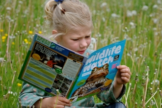 Girl reading Wildlife Watch