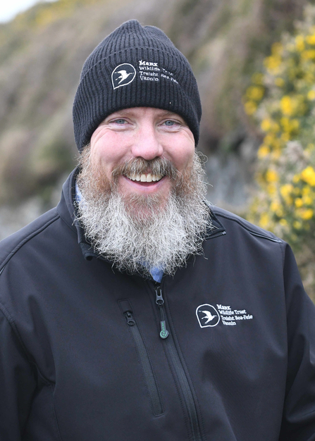 Graham Makepeace-Warne smiling wearing a MWT beanie hat and softshell jacket