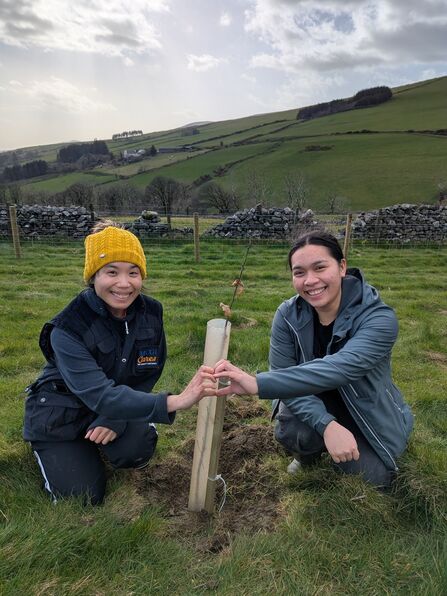  IOMWT; lFaith Caisip and Maryan Jel Garmino, both members of Members Church of God International (MCGI), planting the final tree