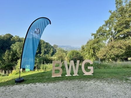 BWG letter and feather flag with landscape background