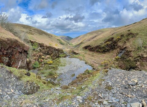 A view over Glen Auldyn, showing hills covered with grass 